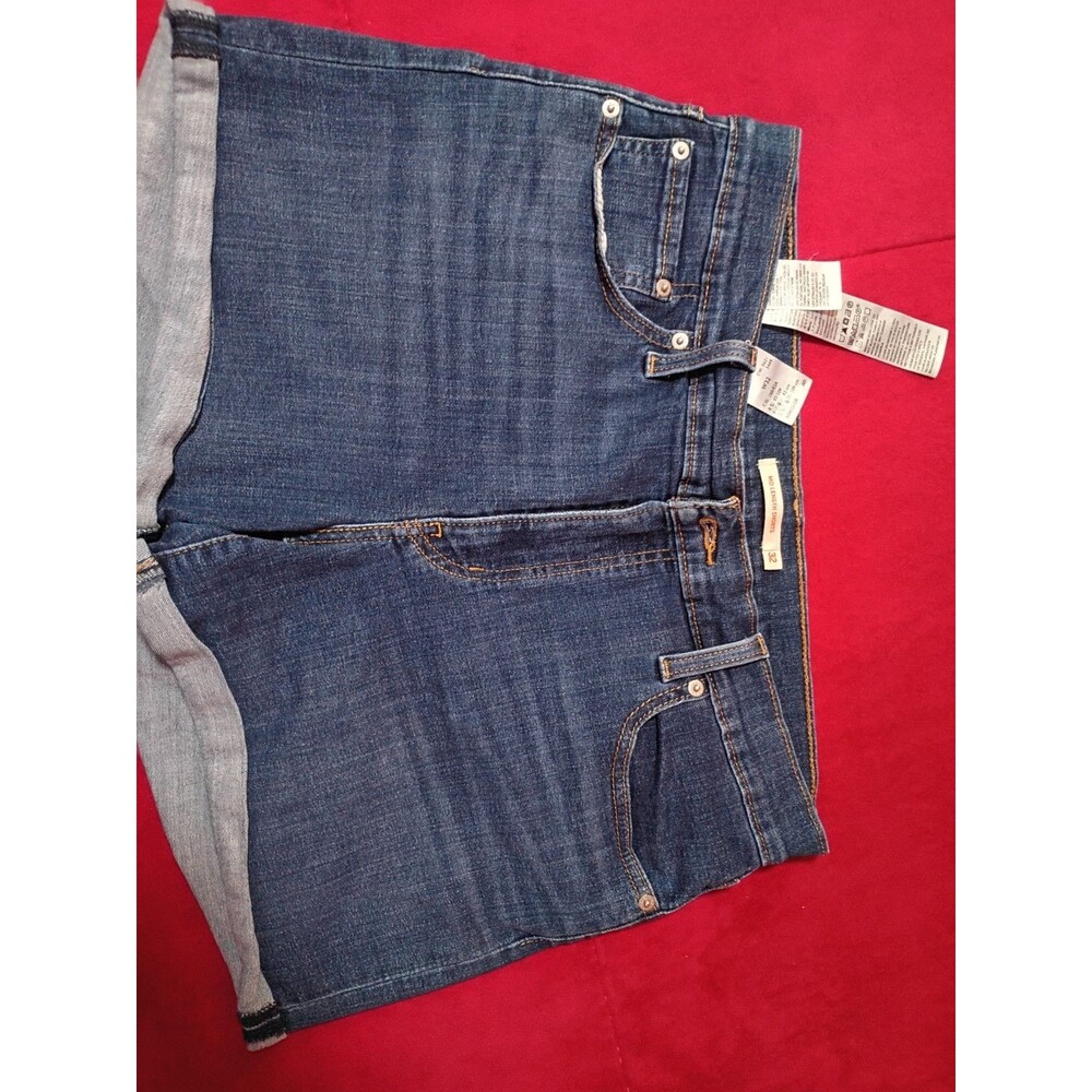 These are Levi's women's mid-length denim shorts, featuring a cuffed hem and